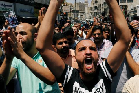 محتجون يرددون هتافات مناهضة لقانون زيادة الضرائب ورفع أسعار الوقود في العاصمة الأردنية عمان يوم الجمعة. تصوير: رويترز. الأردن يجمد زيادة أسعار البنزين بعد موجة احتجاجات