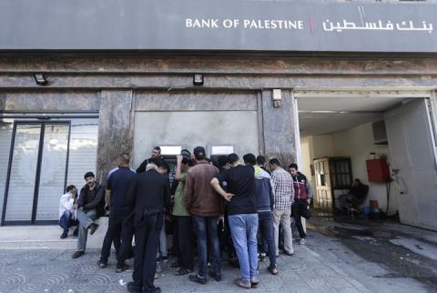 صورة توضيحية-مواطنون أمام صراف آلي لبنك فلسطين في غزة-أرشيف وكالات سمعة البنوك الفلسطينية تحت ضغط دعاوى إسرائيلية