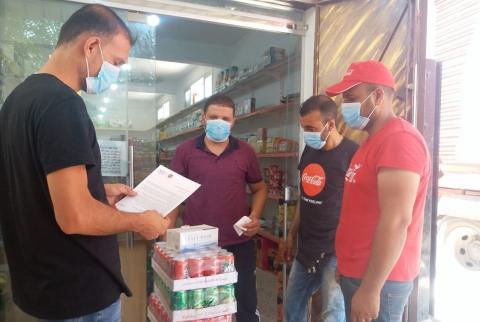 جانب من الحملة المشروبات الوطنية تتبرع بمنتجات وكمامات لخمسة آلاف متجر ومطعم