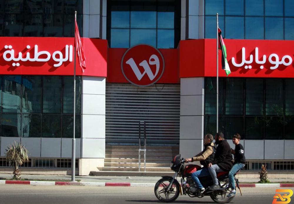 مواطنون يمرون أمام مقر شركة الوطنية موبايل في غزة ’حماس’ تعتقل مسؤولي جوال وتغلق مقر الوطنية موبايل في غزة