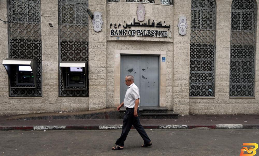 رجل فلسطيني يسير أمام فرع بنك فلسطين في خان يونس-أرشيف رويترز تفاصيل الدعاوى القضائية المرفوعة في محاكم أميركية على بنوك فلسطينية