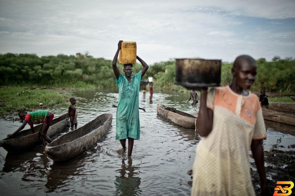 نساء ينقلن المياه من النهر في جنوب السودان-صورة توضيحية-تصوير بابلو توسكو تقرير: 51 مليون شخص في المنطقة العربية يفتقرون للخدمات المائية