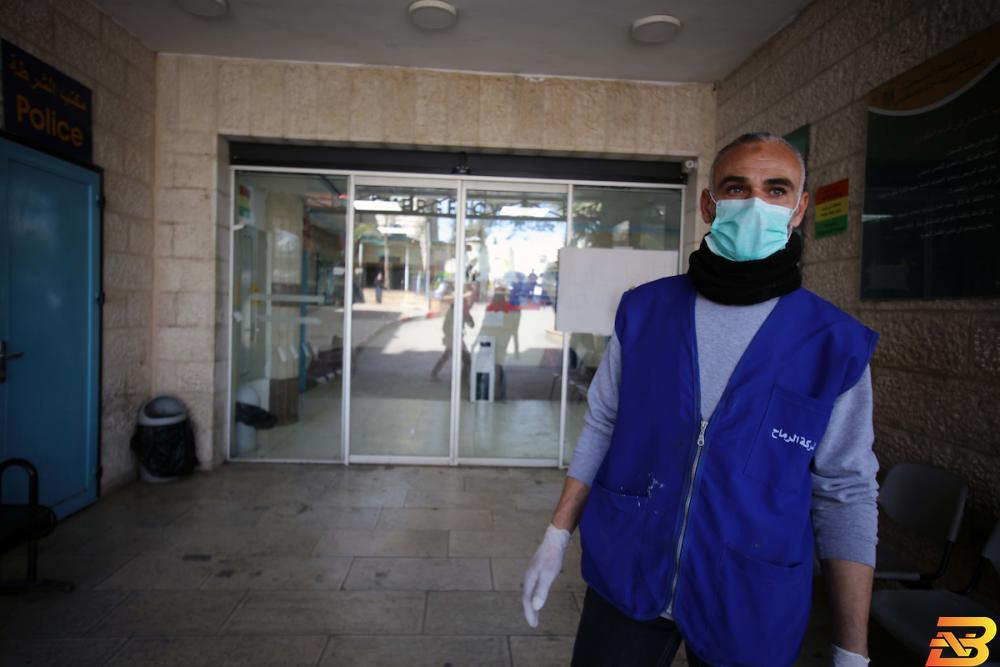فلسطيني يرتدي كمامة واقية ويقف أمام مستشفى بيت جالا الحكومي-تصوير وكالات كل ما تريد معرفته عن فيروس ’كورونا’-أسئلة وأجوبة