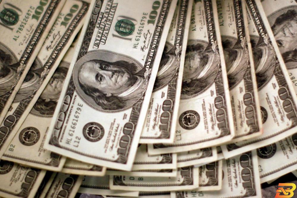 أوراق نقدية من عملة الدولار الأمريكي-تصوير رويترز الدولار قرب أعلى مستوى في شهرين بفضل تعاف أمريكي أقوى نسبيًا